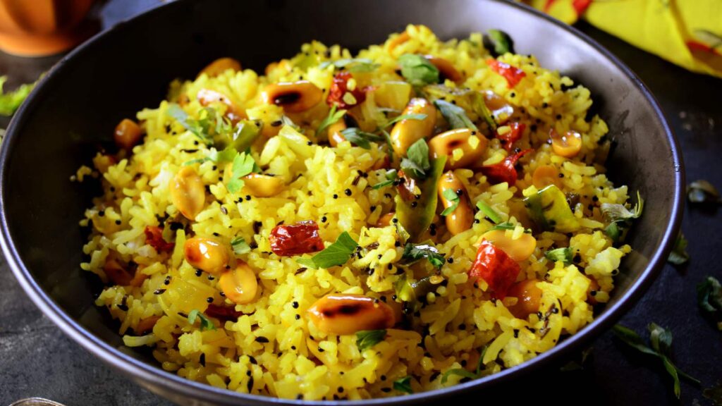 Healthy breakfast featuring traditional Indian poha with peanuts and spices.